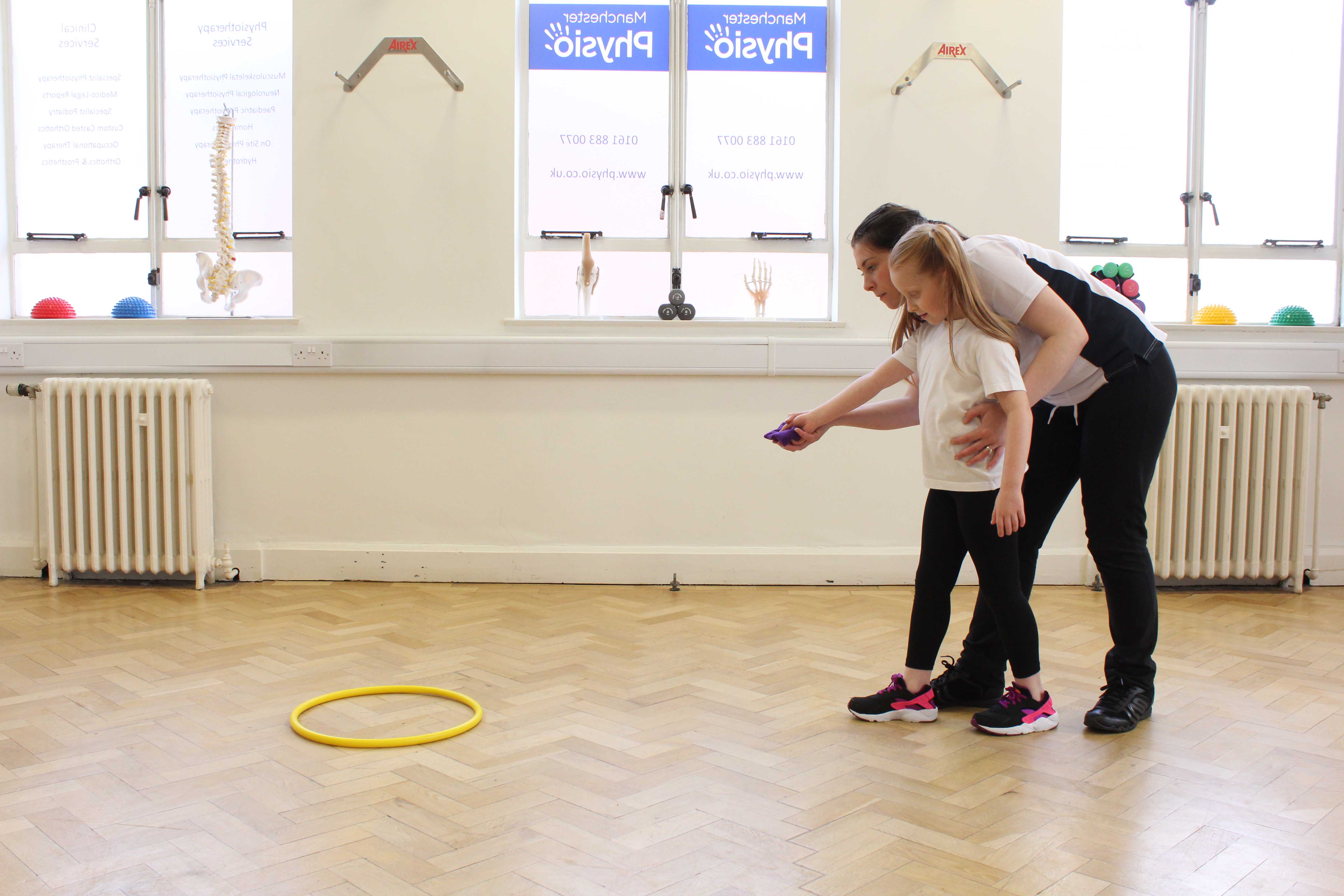 Bridging exerise using a gym ball assisted by a specialised physiotherapist